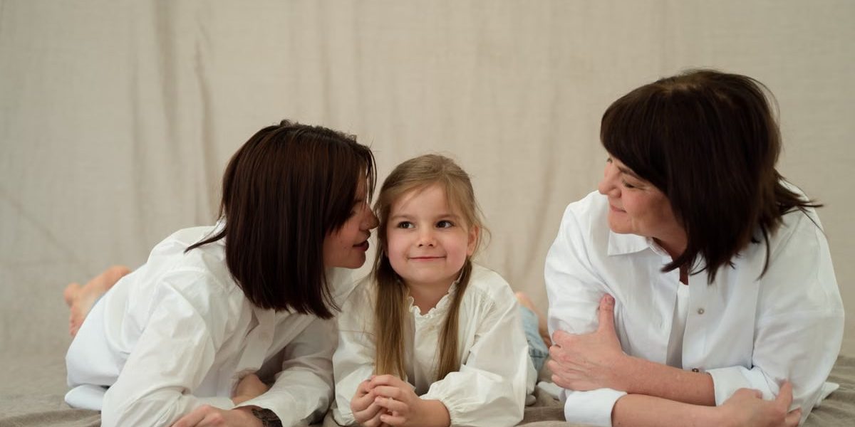 Three generations of women smiling together, symbolizing familial love and connection.