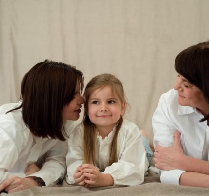 Three generations of women smiling together, symbolizing familial love and connection.