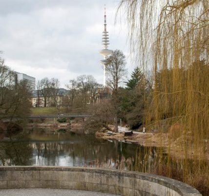 Peaceful landscape of Planten un Blomen Park with view of Fernsehturm in Hamburg, Germany.